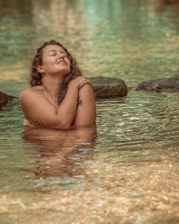 Woman in a dynamic yet calm pose, embodying mindful movement.